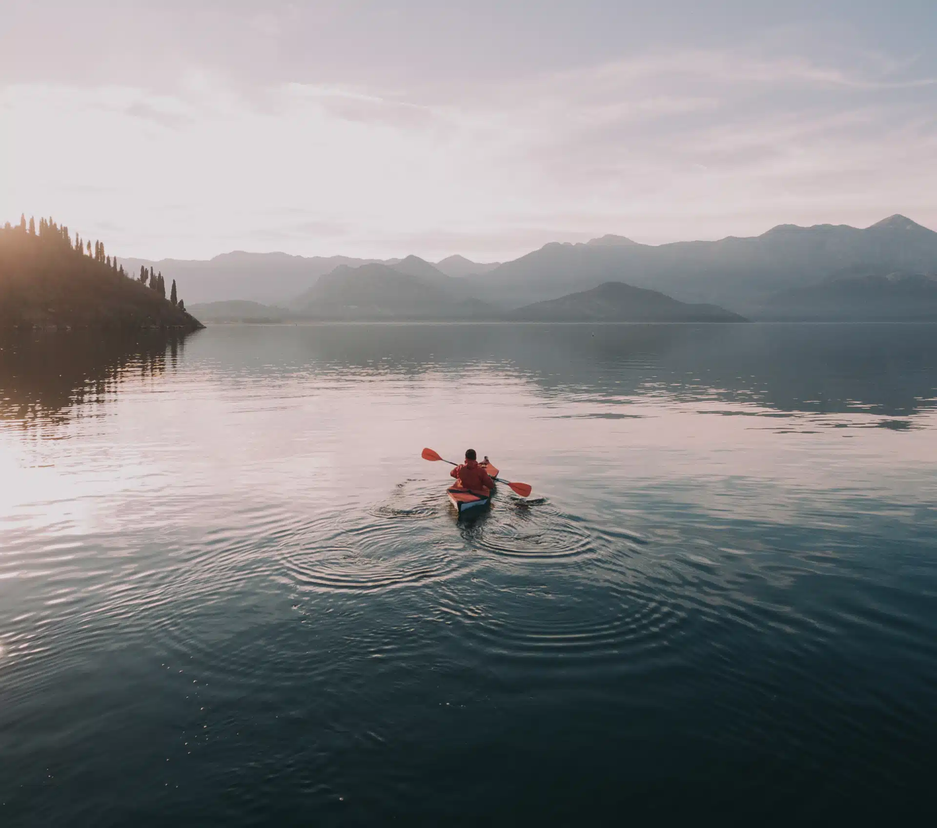 man kayaking in a pristine lake - Webbiz Web services